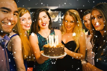 Happy friends celebrating brithday one holding birthday cake - obrazy, fototapety, plakaty