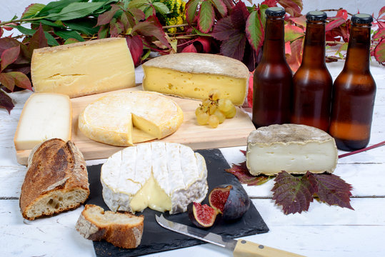 french cheese platter with bottles of beer