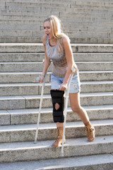 blonde woman with crutches