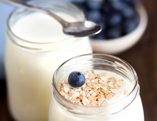Jars of fresh natural yogurt and  blueberries