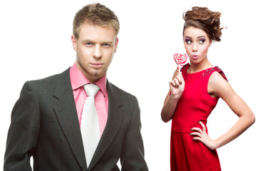 young handsome man holding red heart and cheerful woman on white