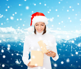 smiling woman in santa helper hat with gift box