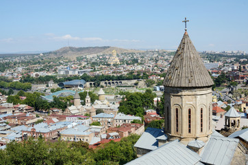Fototapeta na wymiar Roofs of old Tbilisi with top of Saint Bethlehem Church,Gerogia