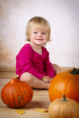 Little girl with pumpkins