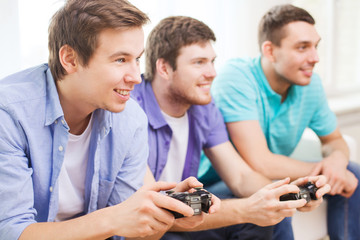 smiling friends playing video games at home