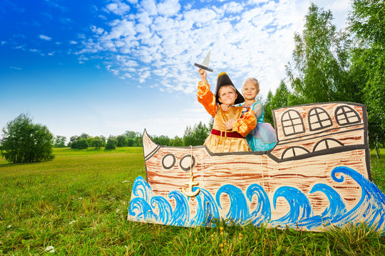 Boy As Pirate And Princess Girl Stand On Ship