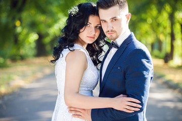 Wedding shot of bride and groom in green park