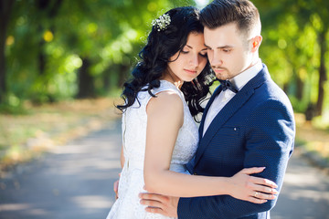 Wedding shot of bride and groom in green park