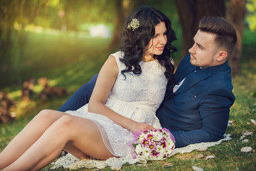 Wedding shot of bride and groom in green park