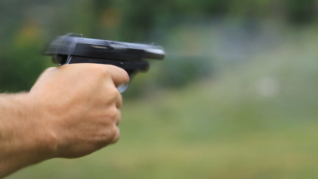 Man firing gun to target
