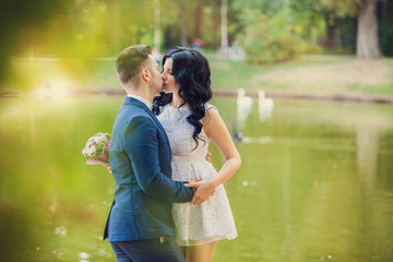 Fototapeta premium Wedding shot of bride and groom in green park