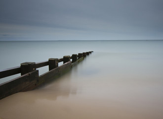 Seascape with smooth water and groyne