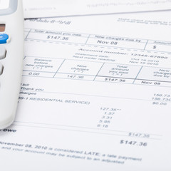Utility bill papers with calculator - 1 to 1 ratio