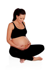 Beautiful pregnant woman sitting on the floor