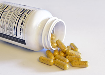 Vitamin pills and bottle on counter