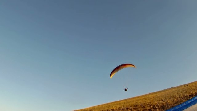 Paraglider taking off from a mountain