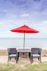 Outdoor table set, beach chairs and red umbrella with beautiful