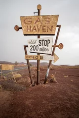 Tall vintage gas sign standing in the desert © piccaya