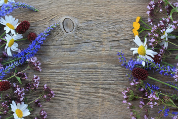 Wild flowers on an old wooden background