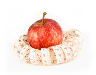 fresh red  juicy  apples fruit and measure tape  on white backgr
