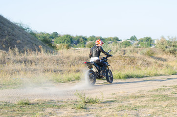 Rider on sport bike for enduro on motocross track