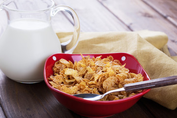 Cornflakes in bowl on table