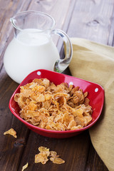 Cornflakes in bowl on table