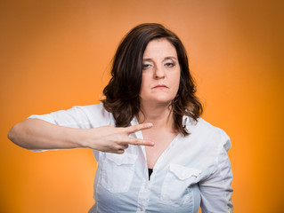 Cut it out all nonsense. Upset angry woman, orange background