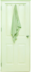 Green towel hang on a white wooden door