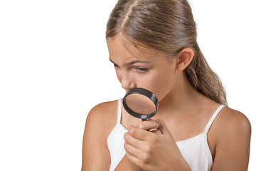 Child looking through a magnifying glass white background 
