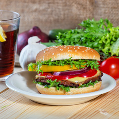 hamburger and drink with slice of lemon