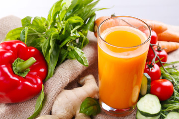 Glass of fresh carrot juice and vegetables