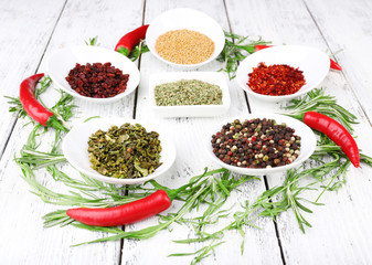 Spice with herbs and dried chilly pepper on wooden background