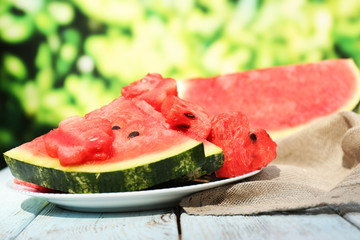 Fresh slices of watermelon on table, outdoors