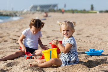 children sitting on beach