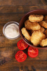 Chicken nuggets with sauce on table close-up
