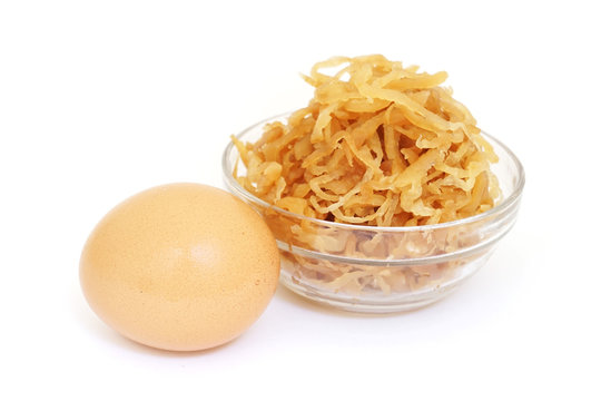 egg and pickled  turnip on white background