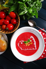 Gazpacho soup on color wooden background
