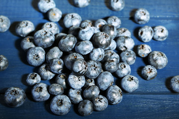 Tasty ripe blueberries, on wooden background