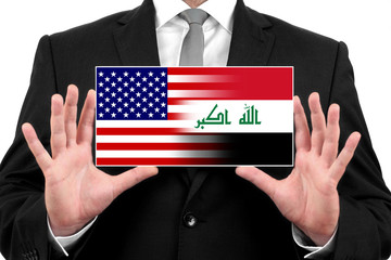 Businessman holding a business card with USA and Iraq Flag
