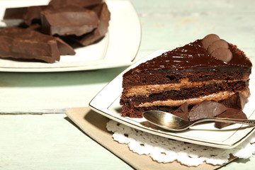 Chocolate cake on plate, on wooden background