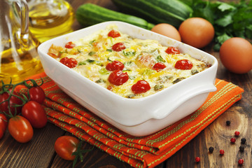 Zucchini baked with chicken, cherry tomatoes and herbs