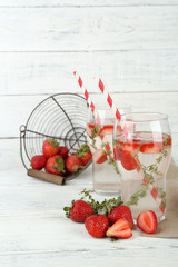 Tasty cool beverage with strawberries and thyme,