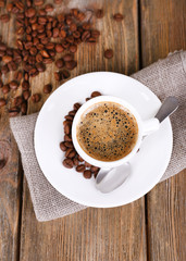 Cup of coffee with milk and coffee beans