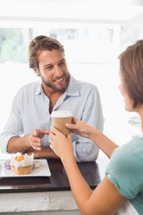 Pretty barista serving happy customer