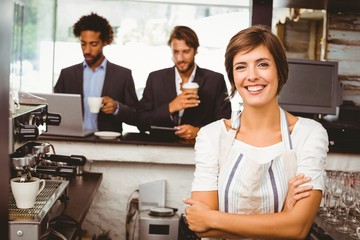 Pretty barista smiling at camera