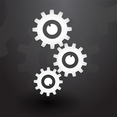 Three white gears on black background