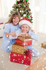 Fototapeta na wymiar Happy brother and sister holding christmas presents