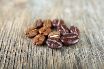Coffee beans with chocolate glaze on wooden background
