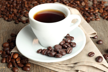 Cup of coffee and coffee beans with chocolate glaze